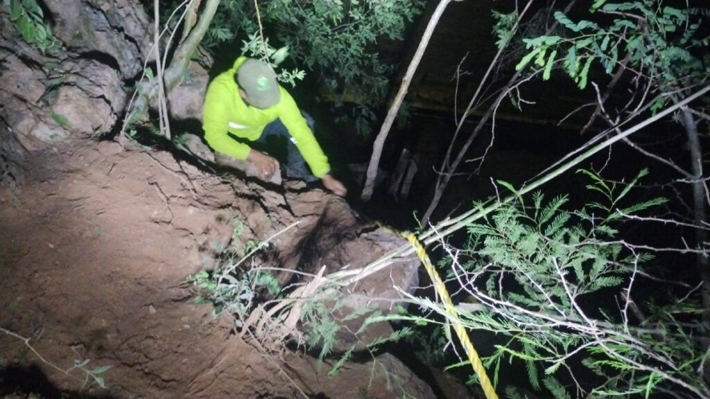 Rescatistas descendiendo cerro hasta el río